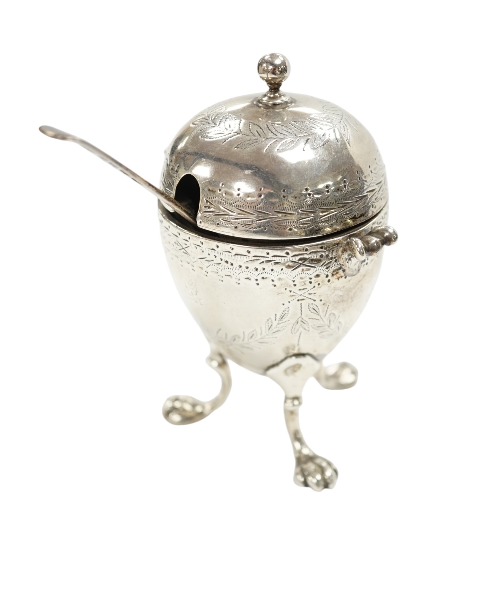 A Victorian silver egg shaped mustard pot, on paw feet, London, 1867, 10.5cm, with an earlier silver mustard ladle. Condition - fair